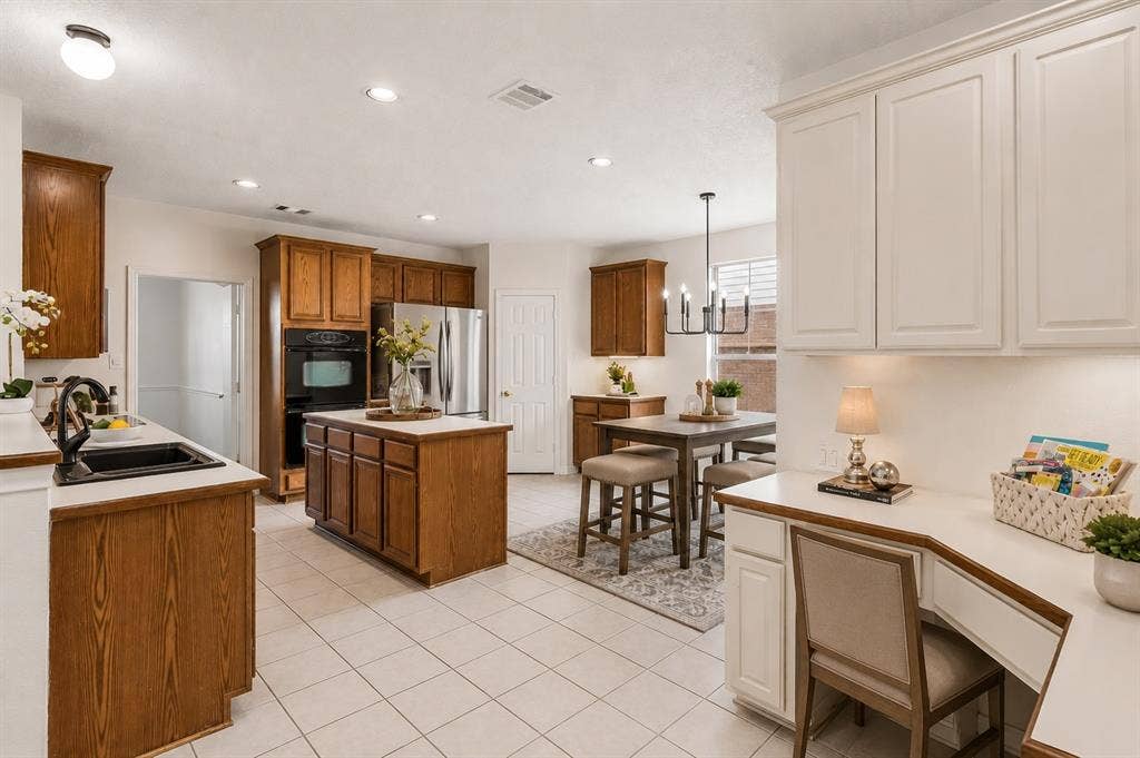 8121 Skyridge Drive, Plano, TX 75025 Spacious kitchen with abundant cabinetry and workspace opens directly to the breakfast nook and soaring family room.*Virtually Staged*