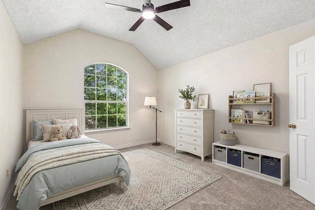 8121 Skyridge Drive, Plano, TX 75025 One of three upstairs bedrooms, featuring brand new carpet, fresh paint and a new ceiling fan with light kit. *Virtually Staged*
