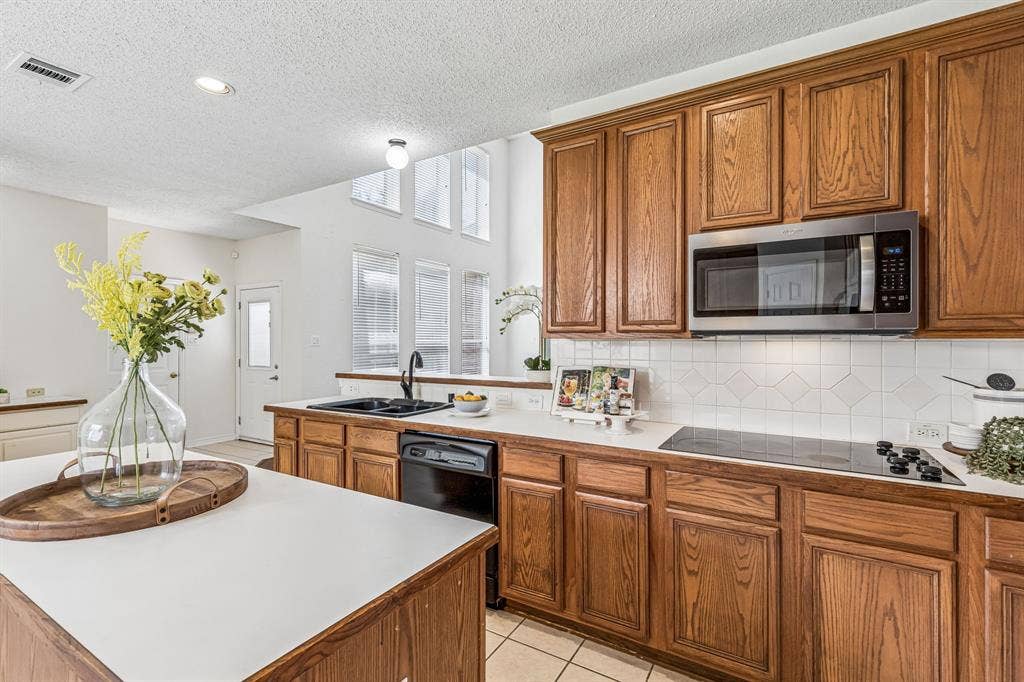 8121 Skyridge Drive, Plano, TX 75025 Open kitchen maintains sightlines to the family room and breakfast area, with gas plumbing available for a future cooktop conversion.