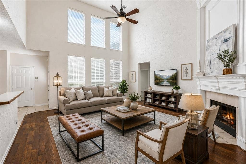 8121 Skyridge Drive, Plano, TX 75025 Soaring two-story ceilings and abundant natural light create a dramatic family room at the heart of the home. *Virtually Staged*
