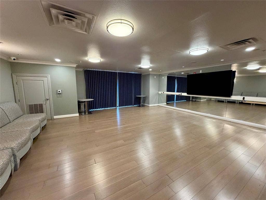330 Las Colinas Boulevard E, #1006, Irving, TX 75039 Hardwood-style flooring, full-wall mirrors, recessed lighting, and modern ceiling light fixtures