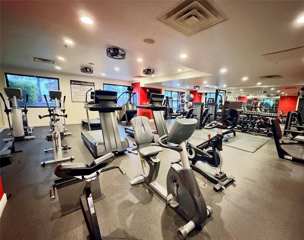 330 Las Colinas Boulevard E, #1006, Irving, TX 75039 Spacious fitness center featuring a rubberized floor, mirrored wall, recessed lighting, and large windows