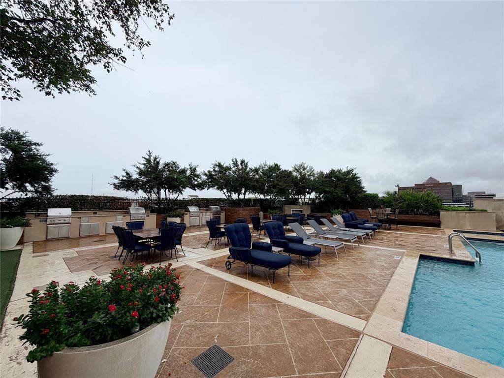 330 Las Colinas Boulevard E, #1006, Irving, TX 75039 Rooftop amenity space featuring a swimming pool, multiple built-in grilling stations, extensive paver patio, and mature landscaping