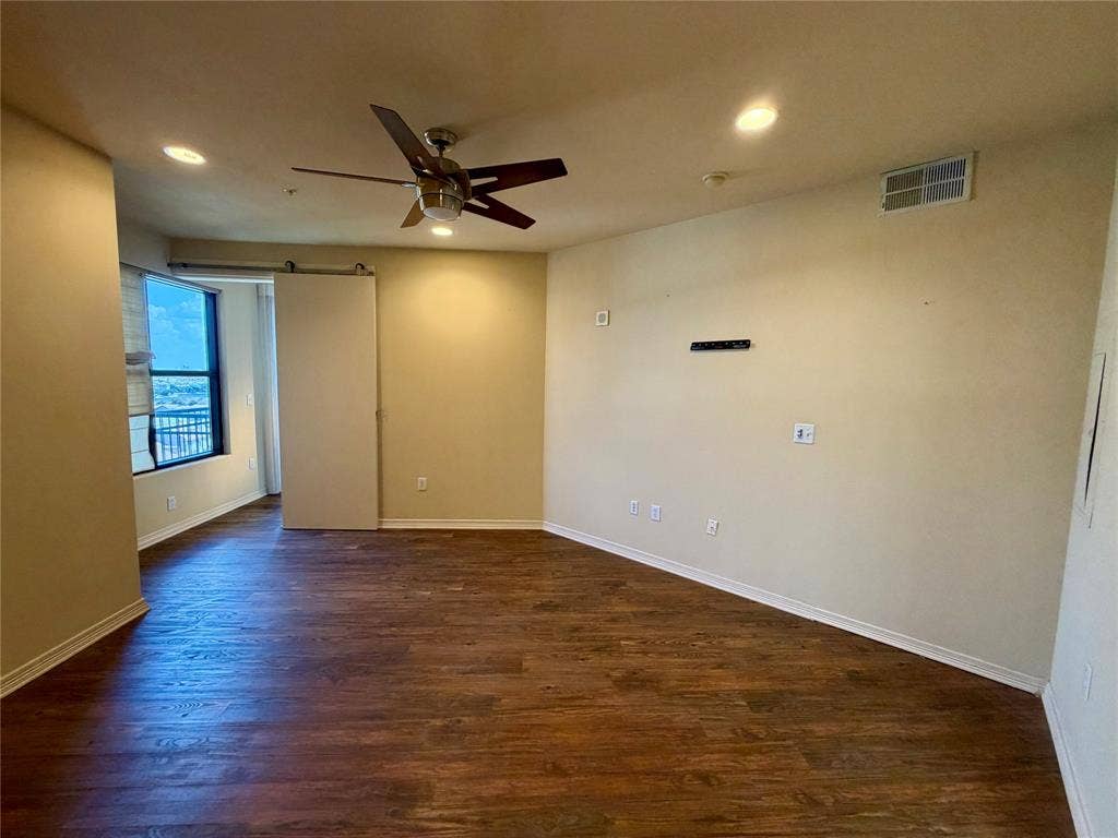 330 Las Colinas Boulevard E, #1006, Irving, TX 75039 Wood-finish flooring throughout, recessed lighting, ceiling fan, and a sliding barn door