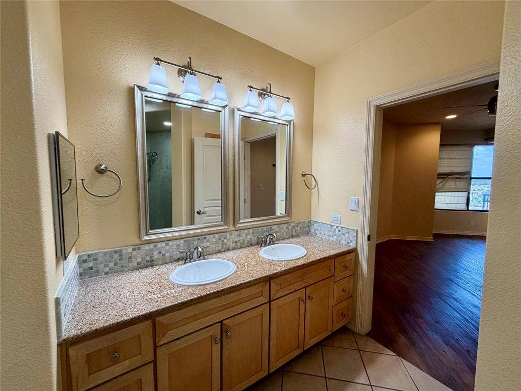 330 Las Colinas Boulevard E, #1006, Irving, TX 75039 Dual vanity with granite countertops, mosaic tile backsplash, and individual framed mirrors