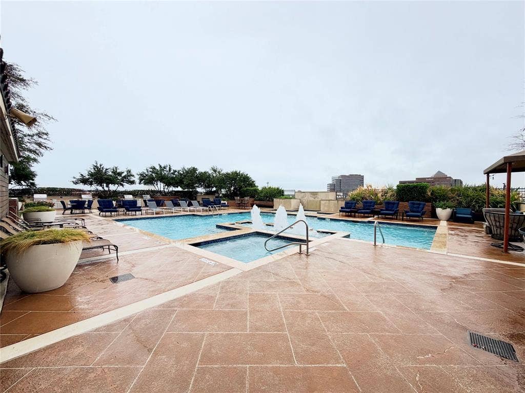 330 Las Colinas Boulevard E, #1006, Irving, TX 75039 Expansive outdoor pool area featuring a rectangular pool, integrated spa, and a textured concrete deck