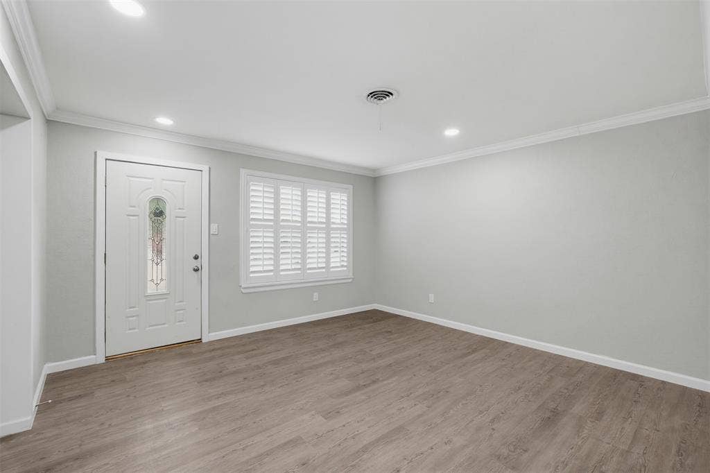 1312 E Mitchell Street, Arlington, TX 76010 Wood-finish flooring, recessed ceiling lighting, crown molding, and white plantation shutters