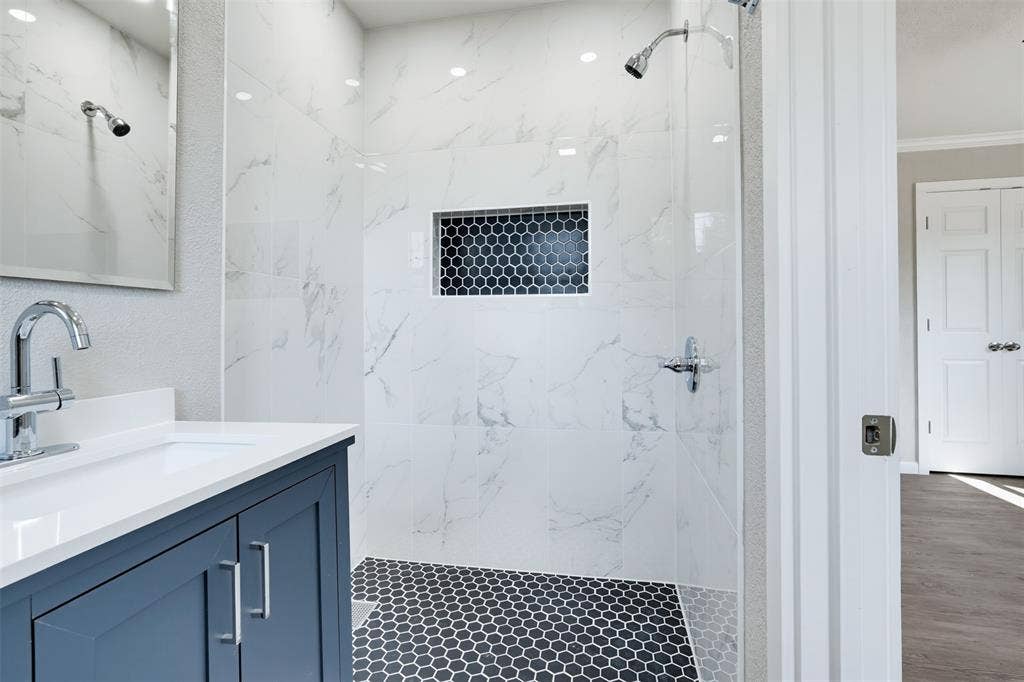 1312 E Mitchell Street, Arlington, TX 76010 Walk-in shower with large format wall tiles and hex tile flooring
