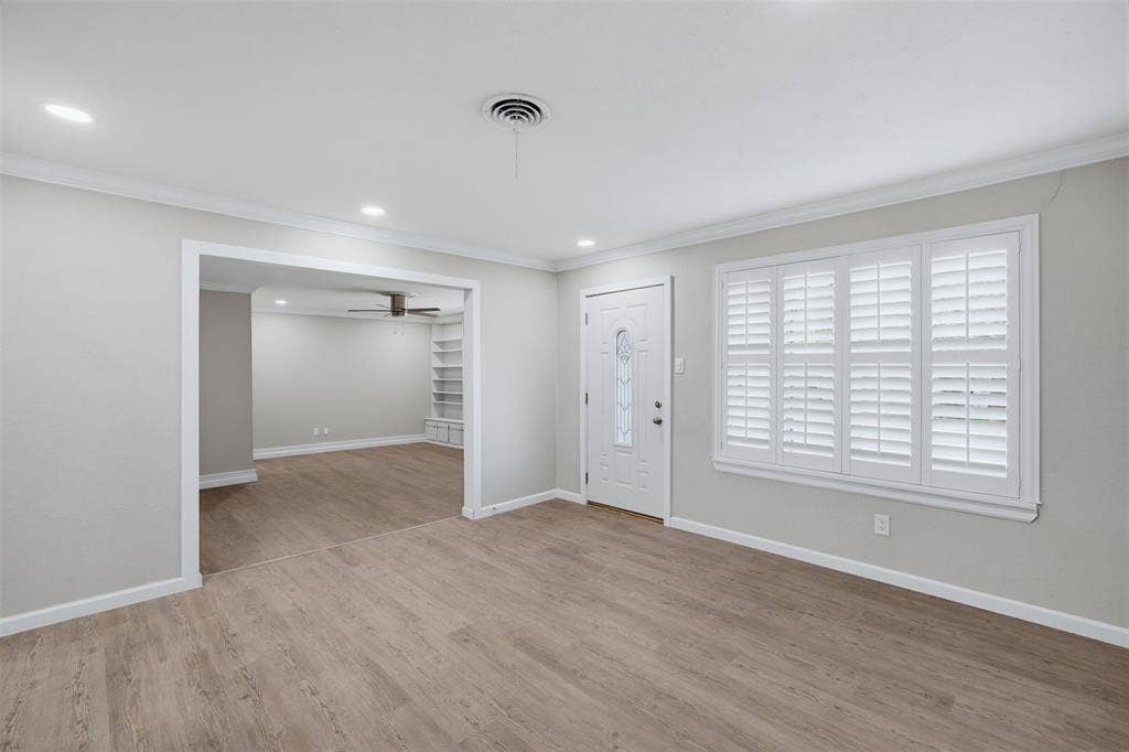 1312 E Mitchell Street, Arlington, TX 76010 Wood-finish flooring throughout, recessed lighting, and a white entry door with decorative glass inlay