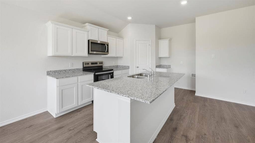 1916 Freeman Street, Tyler, TX 75704 Kitchen featuring white shaker-style cabinetry, stainless steel appliances, granite countertops, and wood-finish flooring