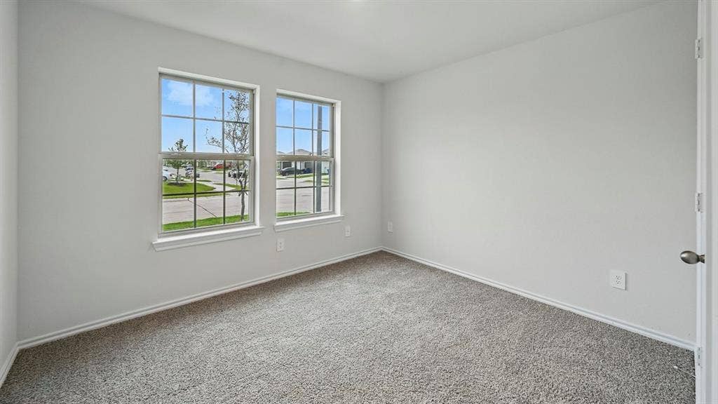 1928 Freeman Street, Tyler, TX 75704 Room featuring neutral carpet flooring, light gray wall paint, and white trim