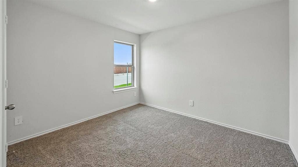 1928 Freeman Street, Tyler, TX 75704 Neutral tone interior space featuring a single window, light gray carpet, white baseboards, and white painted walls