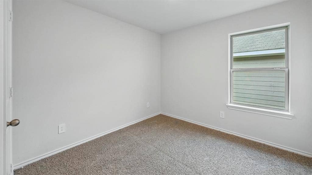 1928 Freeman Street, Tyler, TX 75704 Neutral-toned wall paint and plush carpet flooring define this interior space