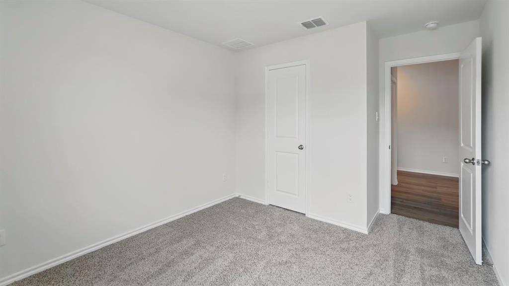 1924 Freeman Street, Tyler, TX 75704 Interior room featuring light grey carpeting, white baseboards, and neutral wall paint