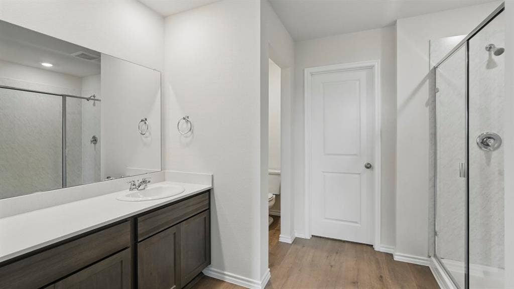 1924 Freeman Street, Tyler, TX 75704 Bathroom featuring a wood-finish vanity with a light-colored countertop and integrated sink