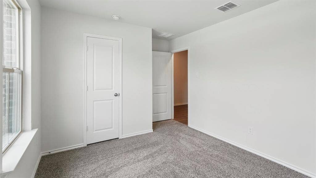 1924 Freeman Street, Tyler, TX 75704 Spacious interior room featuring light gray carpet flooring, white painted walls, and white trim