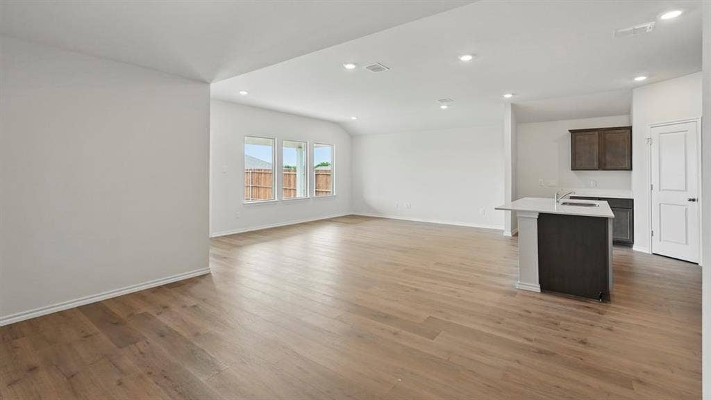 1924 Freeman Street, Tyler, TX 75704 Expansive open-concept living area featuring wood-finish flooring, recessed lighting, and multiple windows
