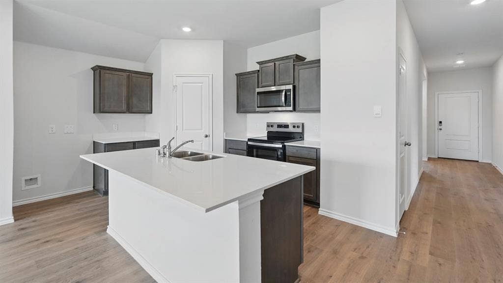 1924 Freeman Street, Tyler, TX 75704 Kitchen island featuring a double basin stainless steel sink and a stainless steel faucet