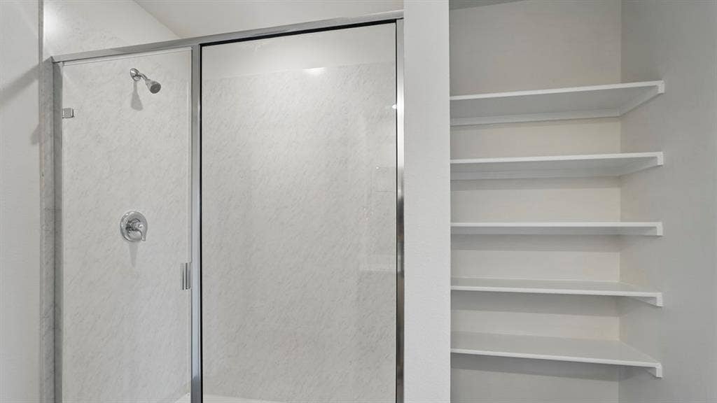1924 Freeman Street, Tyler, TX 75704 Shower enclosure with chrome fixtures and integrated shelving