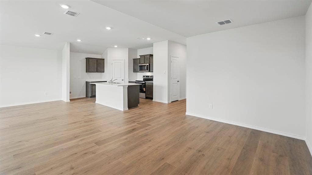 1924 Freeman Street, Tyler, TX 75704 Open-concept living area featuring wood-finish flooring, recessed lighting, and a neutral color palette