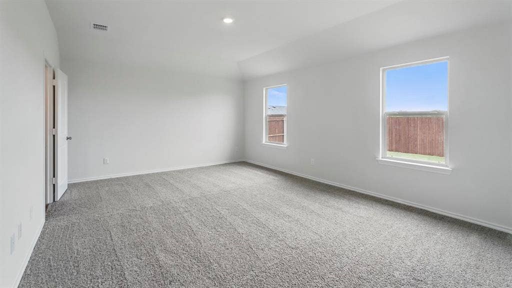 1924 Freeman Street, Tyler, TX 75704 Spacious room with new gray carpet, white walls, two windows, and a flush-mount ceiling light