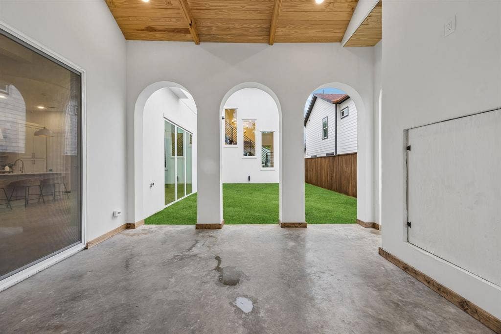 3027 Brooklyndell Avenue, Dallas, TX 75211 Covered patio featuring a wood-finish ceiling with recessed lighting and three arched openings leading to the yard
