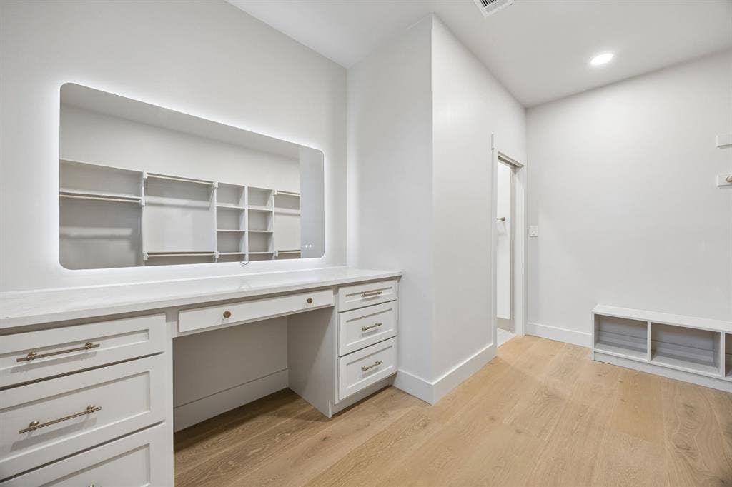 3027 Brooklyndell Avenue, Dallas, TX 75211 The walk-in primary closet features a vanity