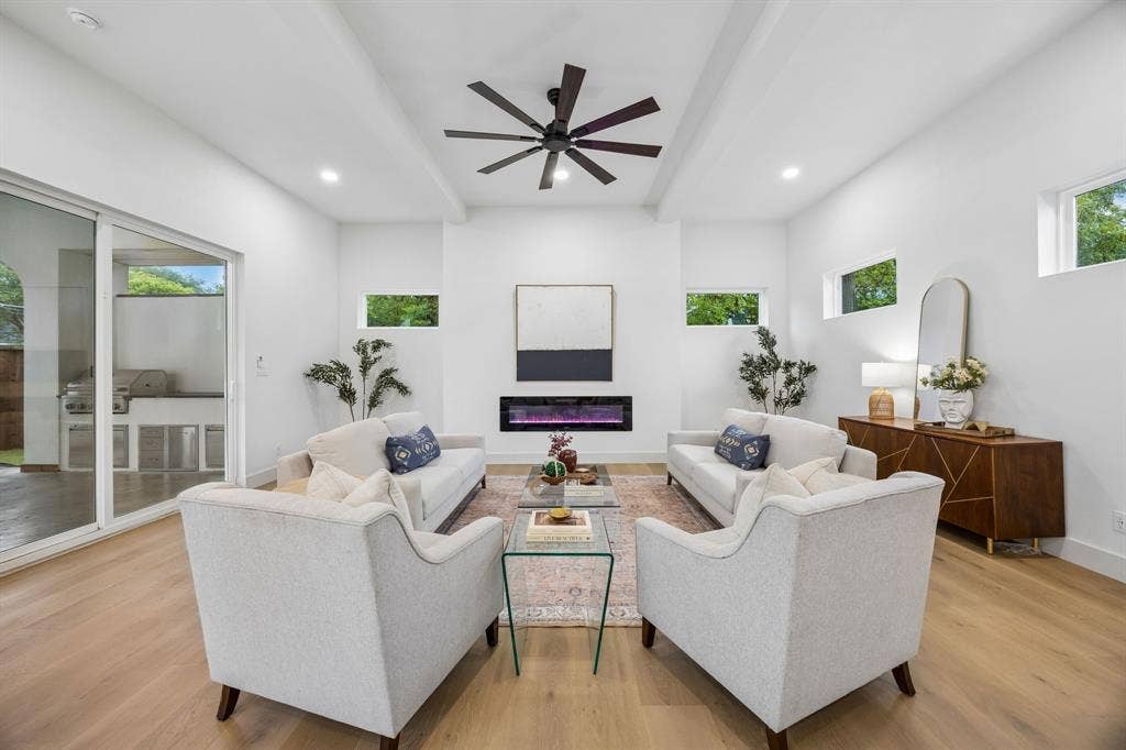 3027 Brooklyndell Avenue, Dallas, TX 75211 Expansive living area with high ceilings, an electric fireplace and a ceiling fan