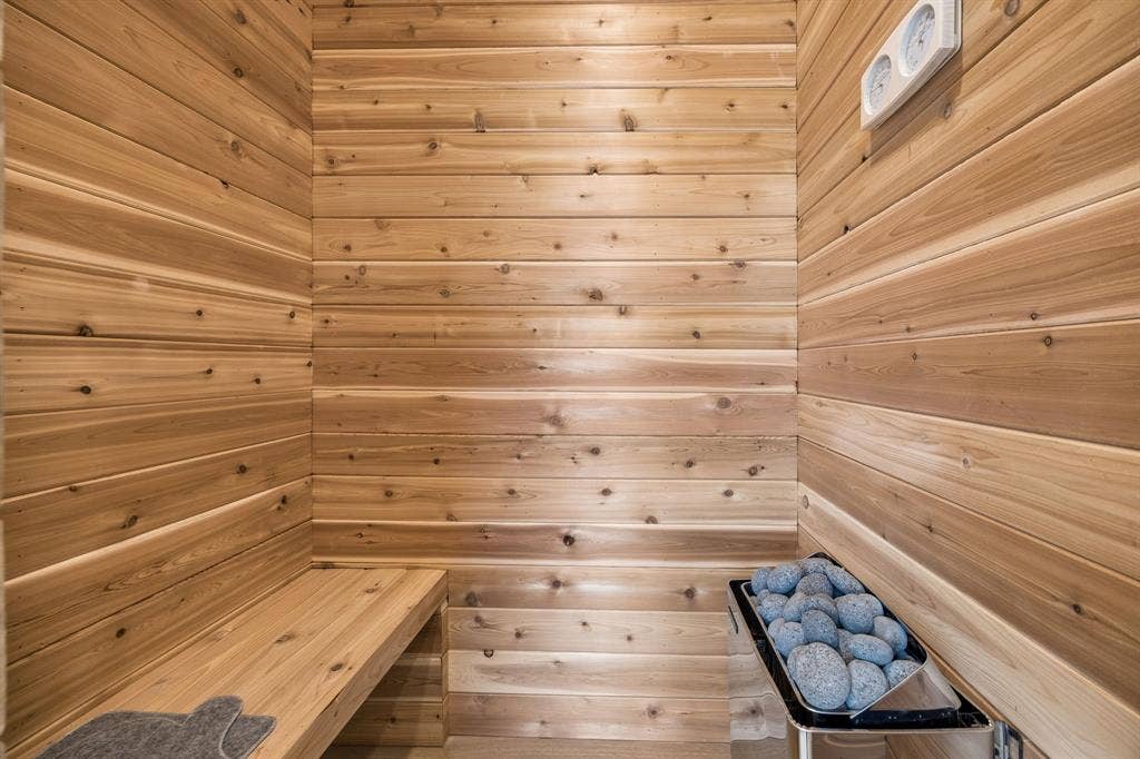3027 Brooklyndell Avenue, Dallas, TX 75211 Wood paneling, built-in wooden bench, integrated heater with stones, wall-mounted control panel
