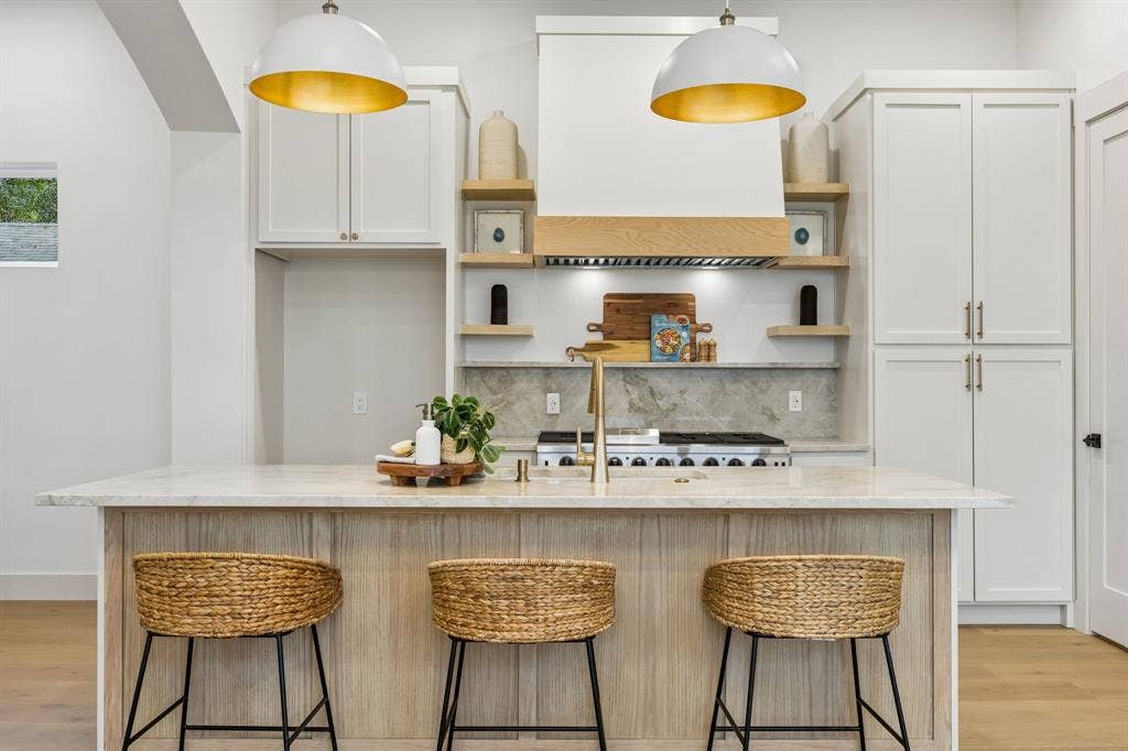 3027 Brooklyndell Avenue, Dallas, TX 75211 Kitchen island featuring two dome pendant lights with gold interiors