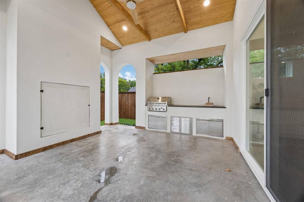 3027 Brooklyndell Avenue, Dallas, TX 75211 Covered back patio with exposed beams, integrated outdoor kitchen with stainless steel appliances