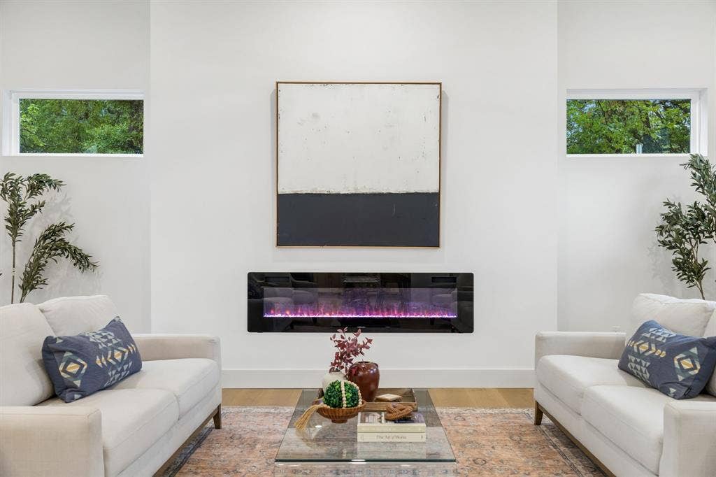 3027 Brooklyndell Avenue, Dallas, TX 75211 Wall-mounted electric fireplace with a black glass front