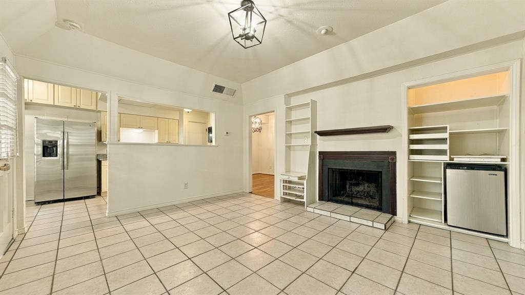 4325 Bellaire Drive S, Fort Worth, TX 76109 den wood burning fireplace, built in shelves, mini frig, view to kitchen