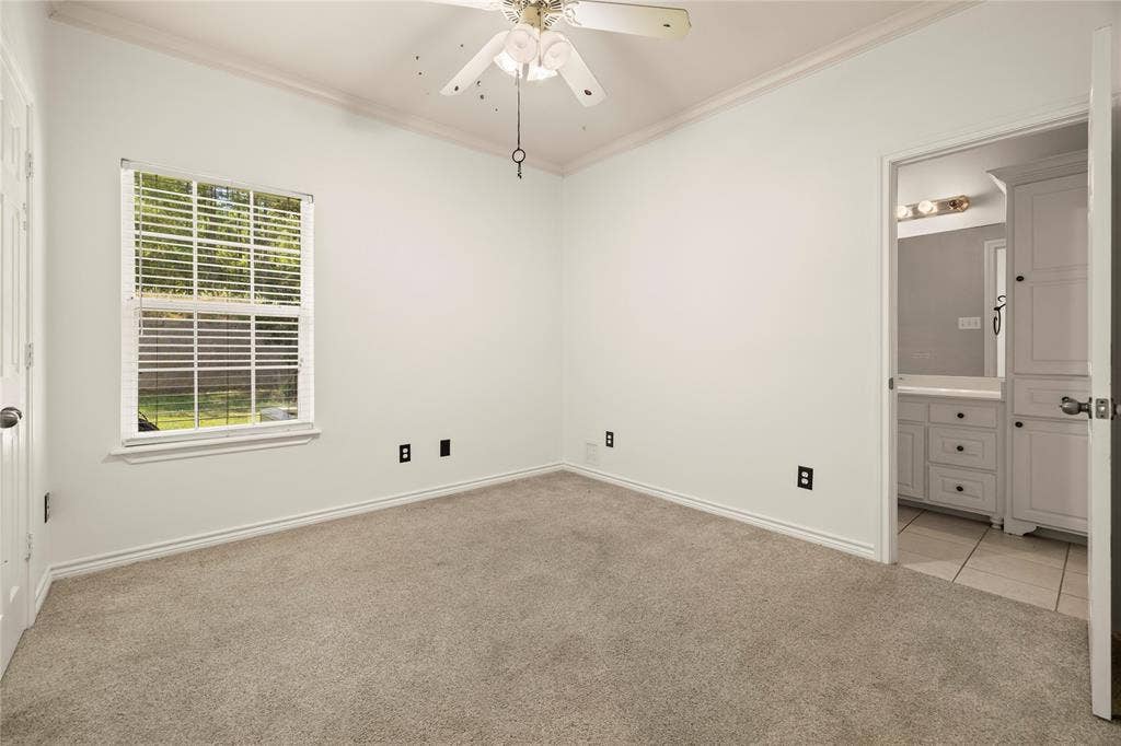 618 Huntwick Lane, Tyler, TX 75703 Carpeted room with a window, ceiling fan, and crown molding