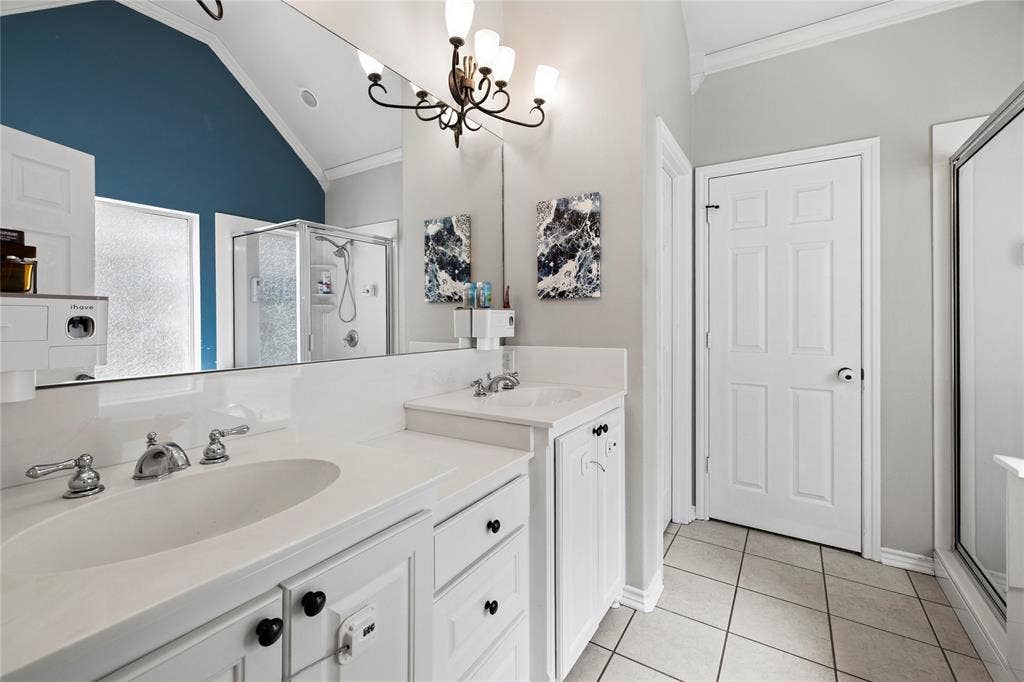 618 Huntwick Lane, Tyler, TX 75703 Double vanity with integral sinks, white cabinetry, chrome fixtures, and a large mirror