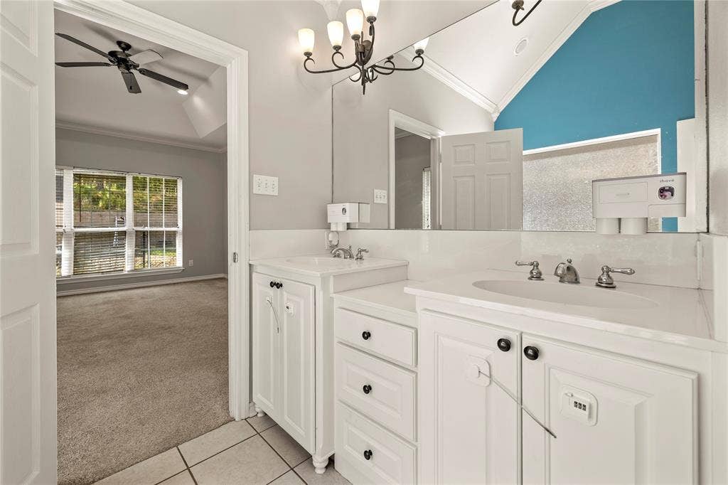 618 Huntwick Lane, Tyler, TX 75703 Dual white vanities with integrated sinks, chrome fixtures, tile flooring, and a large wall-mounted mirror