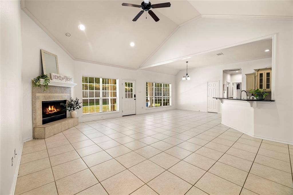 618 Huntwick Lane, Tyler, TX 75703 Vaulted ceiling with a ceiling fan, recessed lighting, corner fireplace with a mantel, tiled flooring, and multiple windows