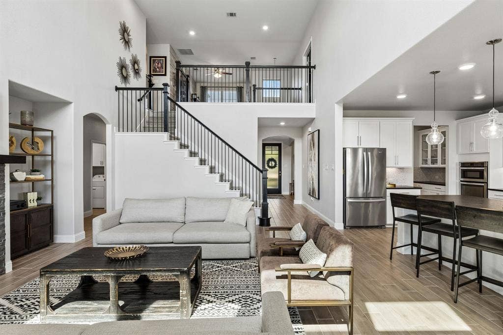 3707 Roth Drive, McKinney, TX 75071 Expansive open living area showcases the home’s exceptional sense of scale, with spacious gathering areas, a dramatic staircase, fireplace, and beautifully appointed kitchen creating an ideal entertaining environment.