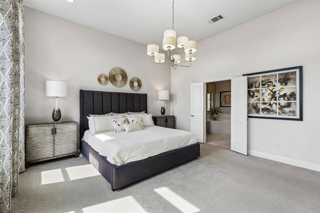 3707 Roth Drive, McKinney, TX 75071 Spacious primary suite offers a refined retreat with statement lighting and direct access toward the luxurious ensuite.
