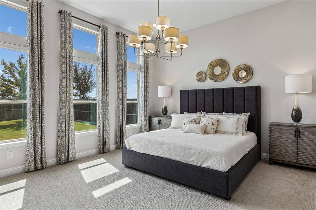 3707 Roth Drive, McKinney, TX 75071 Luxurious primary retreat is filled with natural light and features soaring windows, designer-style lighting, and a serene neutral palette.