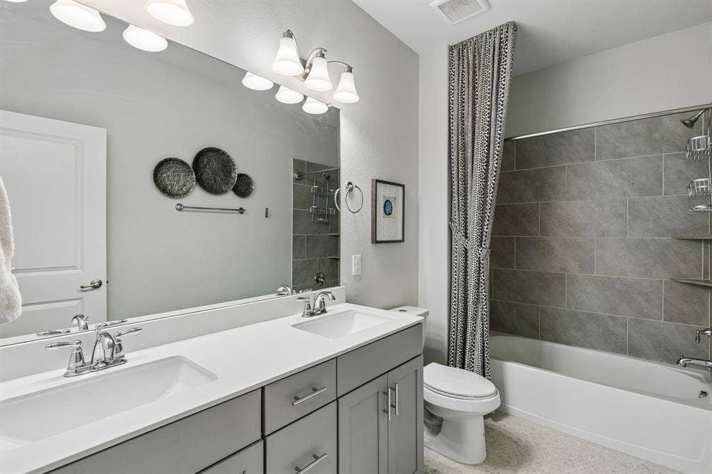 3707 Roth Drive, McKinney, TX 75071 This hall bathroom services upstairs bedroom 2 & 3.
