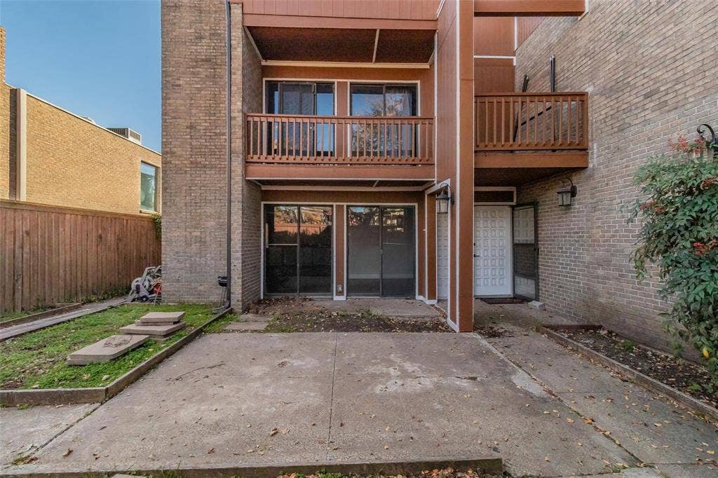 4930 Thunder Road, Dallas, TX 75244 Brick exterior with wood-finish siding, ground-level patio, and an upper-level balcony