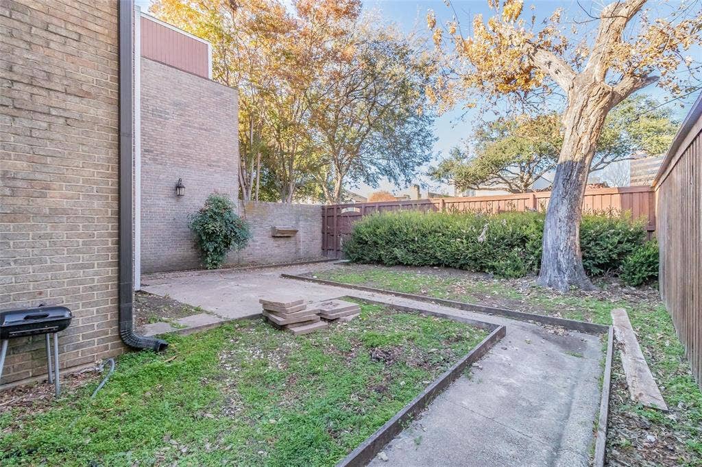 4930 Thunder Road, Dallas, TX 75244 Brick exterior with an outdoor wall-mounted light fixture