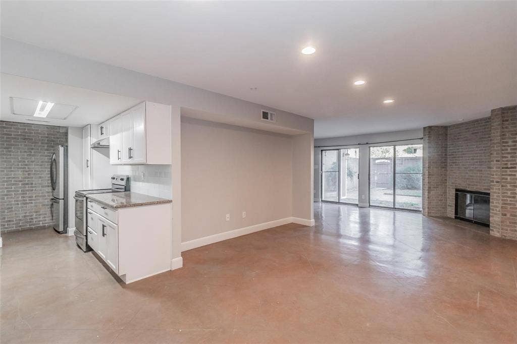 4930 Thunder Road, Dallas, TX 75244 Kitchen with white cabinetry, stainless steel appliances, and stone countertops