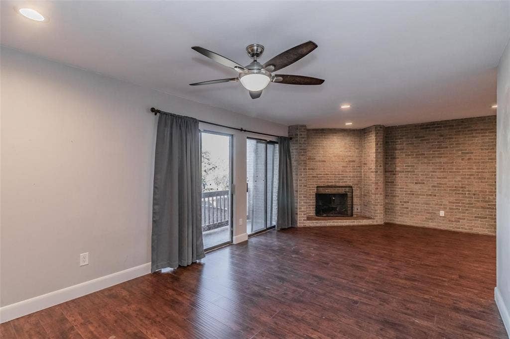 4930 Thunder Road, Dallas, TX 75244 Wood-finish flooring, recessed lighting, ceiling fan, brick-faced fireplace, and sliding glass doors