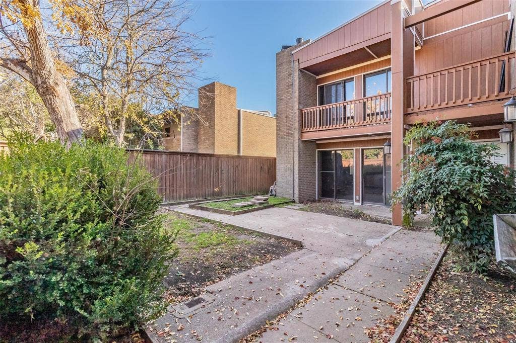 4930 Thunder Road, Dallas, TX 75244 Concrete patio with integrated planting beds, wood fencing, and mature landscaping