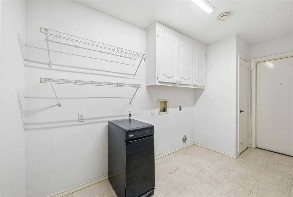 4424 Westridge Avenue, Fort Worth, TX 76116 White wall-mounted cabinetry, integrated wire shelving, and tiled flooring
