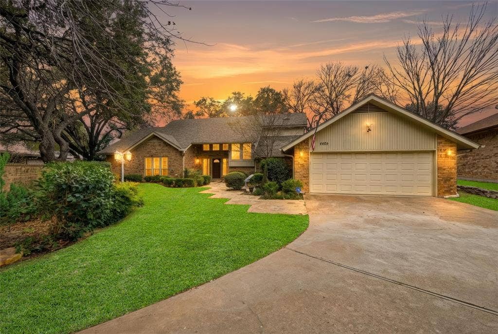 4424 Westridge Avenue, Fort Worth, TX 76116 Brick exterior with a detached garage, concrete driveway, and manicured landscaping