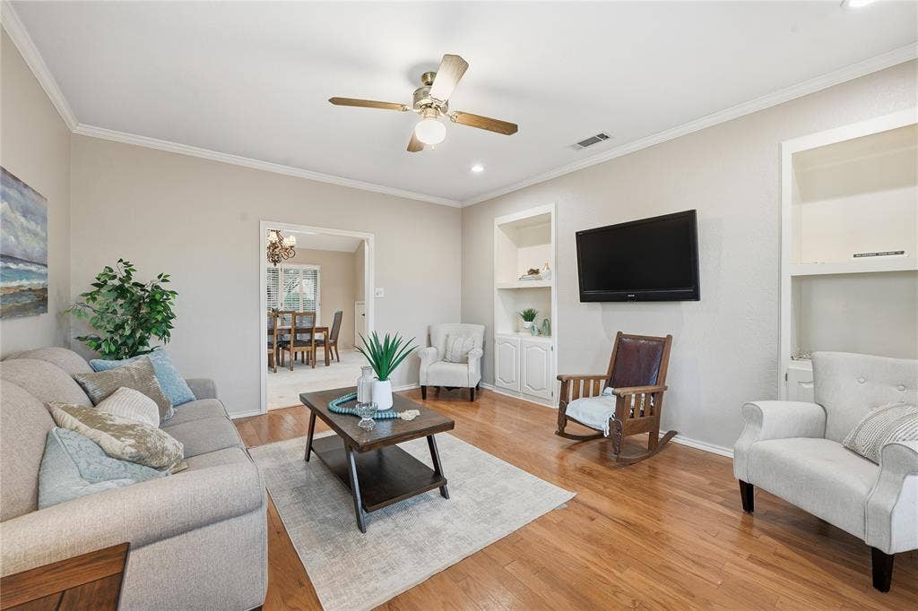 4424 Westridge Avenue, Fort Worth, TX 76116 Wood-finish flooring throughout, ceiling fan with integrated lighting, and built-in shelving with lower cabinetry