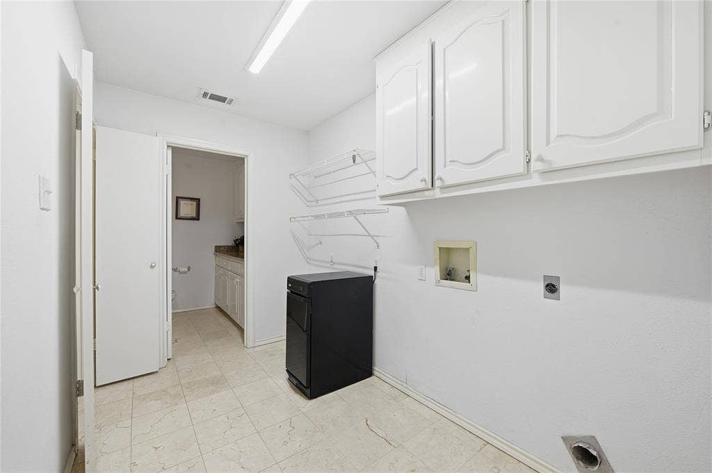 4424 Westridge Avenue, Fort Worth, TX 76116 White upper cabinetry, permanent wall shelving, and tile flooring